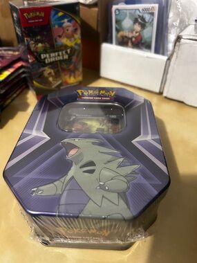 Pokemon Tin Featuring Green Tyranitar on Blue and Purple Artwork